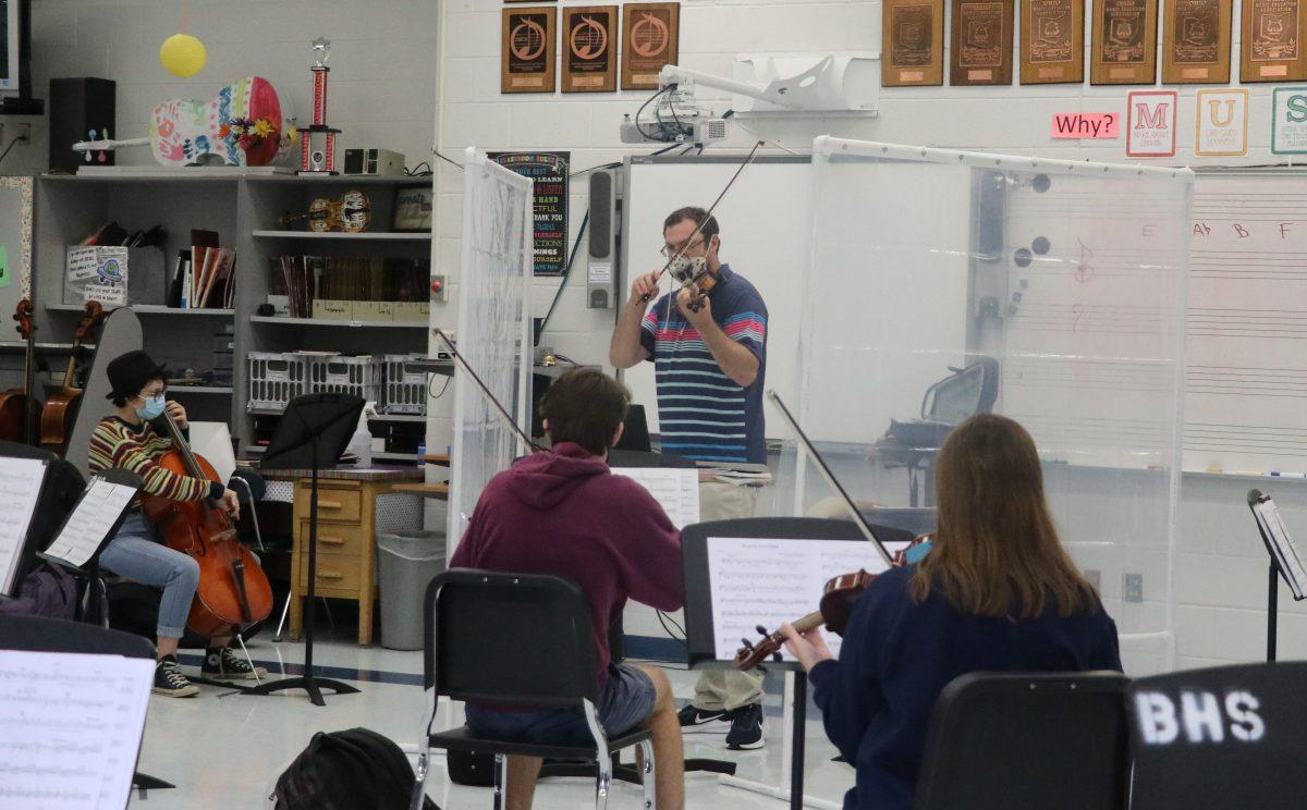 Students rehearse with orchestra teacher Steven Spangler for the first time in person. (Photo by Claire MacDonald)