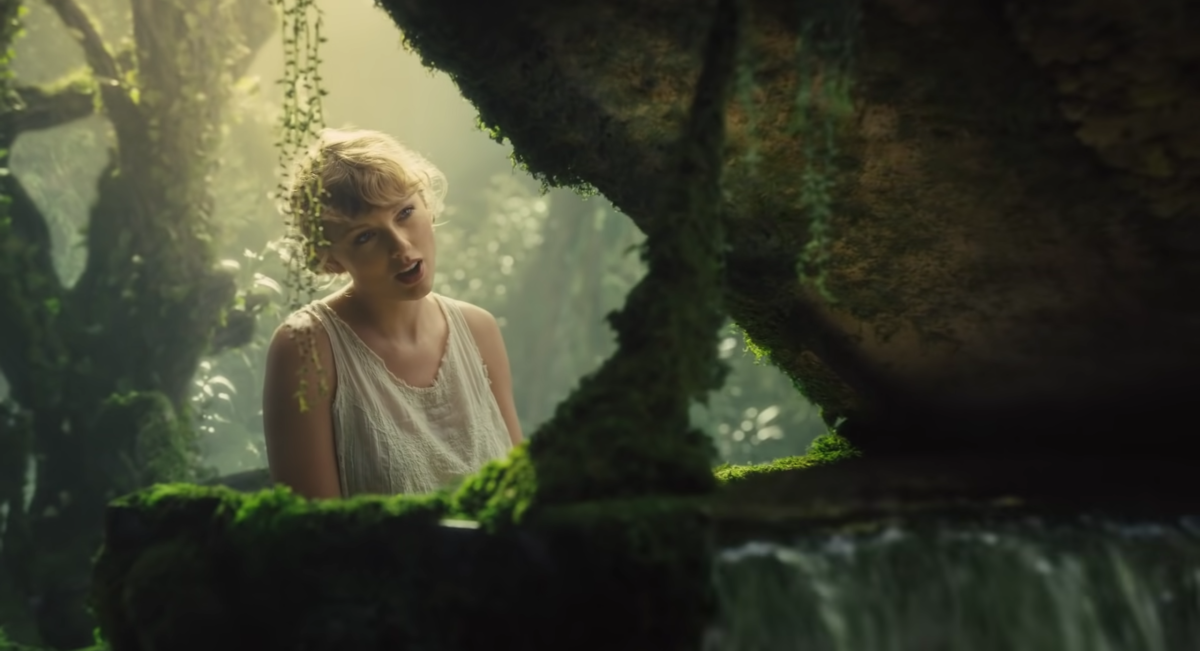 Taylor Swift performs at a moss-covered piano in the music video for "Cardigan" off of her new album "Folklore." (Fair use from YouTube)