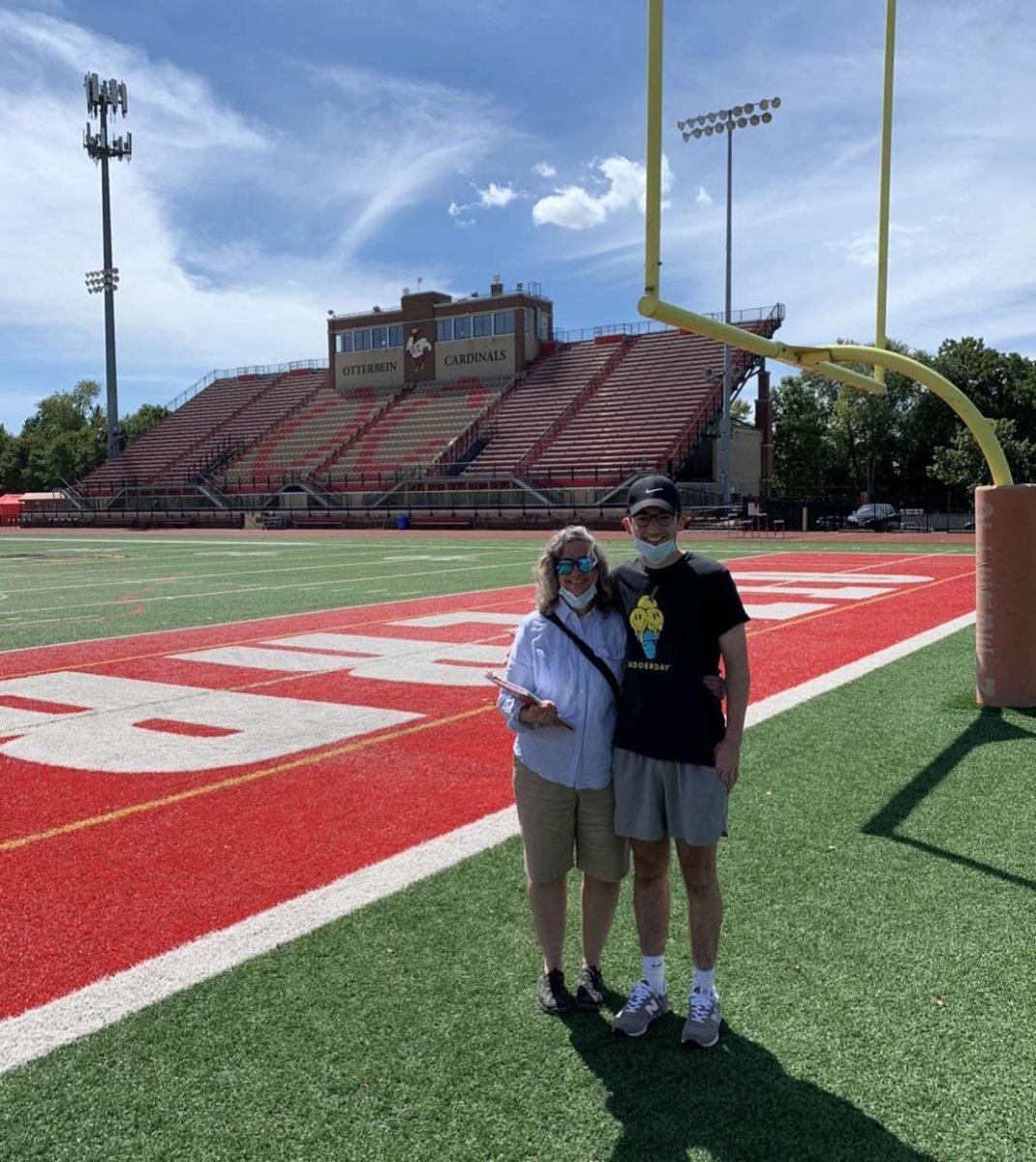 Senior Tyler Owens-Terwilliger (right) and his mother (left) stand in front of Otterbein University's stadium. (Photo by Harley Carroll)