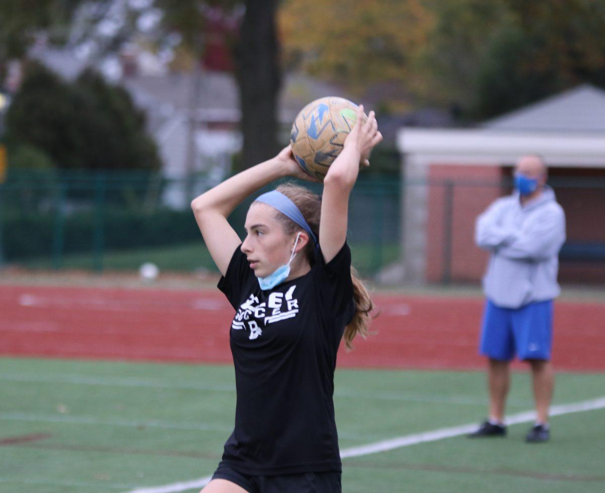 Sophomore Anna Hollo prepares to throw the ball back in play during a soccer practice. (Photo by Joey Shapiro)