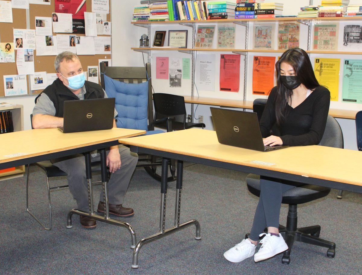 Junior Katie Liu receiving help in the English Resource Center from Mr. Thomich. (Photo by Emma Magee)