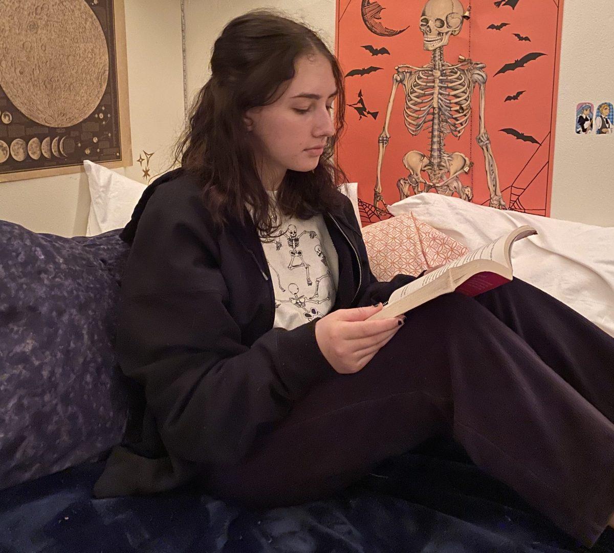 Junior Georgia Booth spends time reading a book in her room to de-stress during the winter. (Photo courtesy of Georgia Booth)