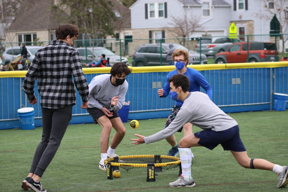 Junior Miller MacDonald prepares to assist his teammate senior Elliot Roe during a game of round net. (Photo by Matt Cohn)