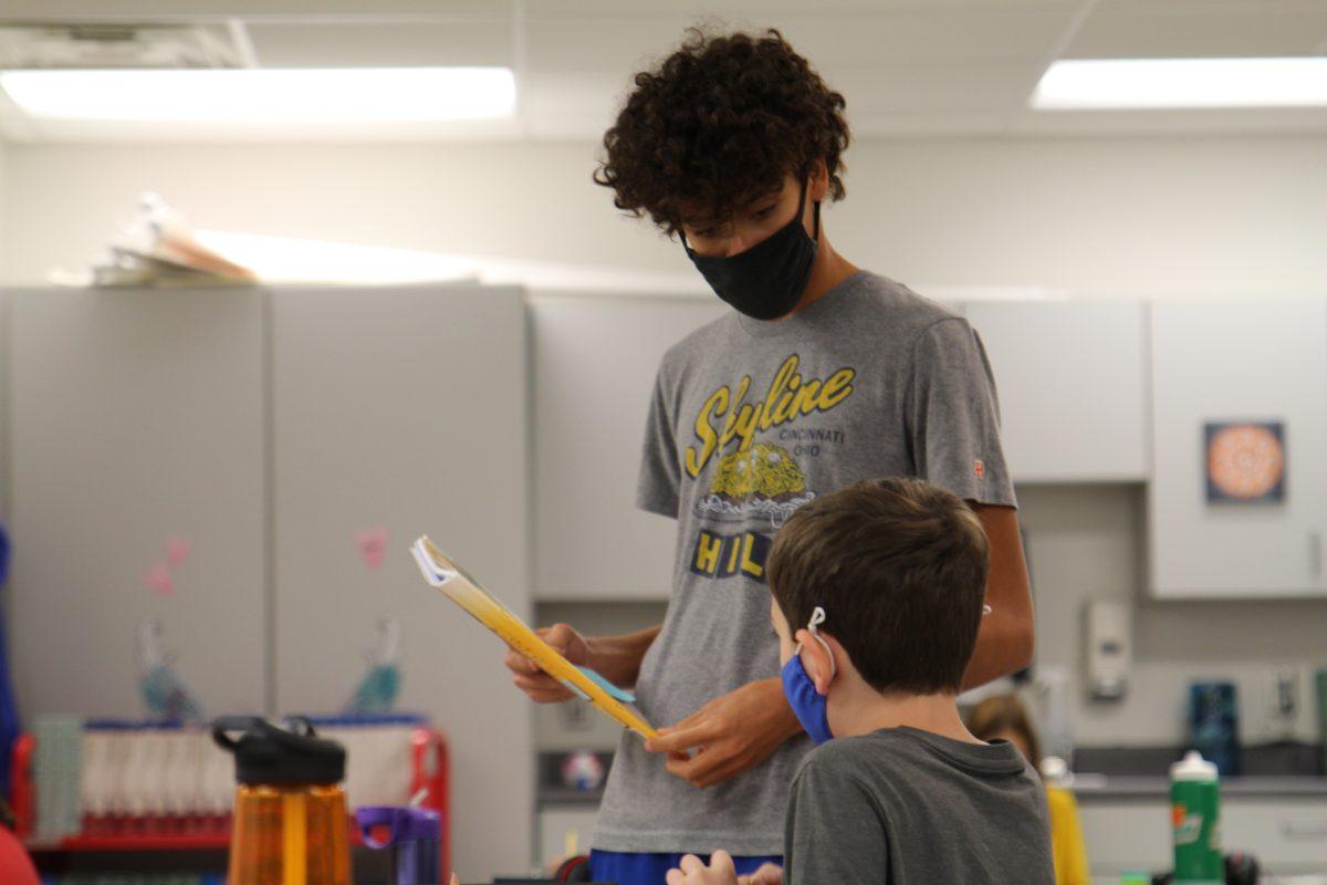 Senior Elijah Dresbach helps first-grade student at Cassingham.