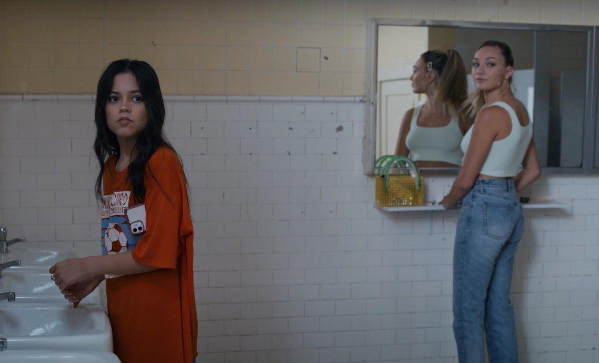 Vada (Jenna Ortega) and Mia (Maddie Ziegler) hear gunshots from the
school hallway while in the restroom. (Fair use Indiewire)