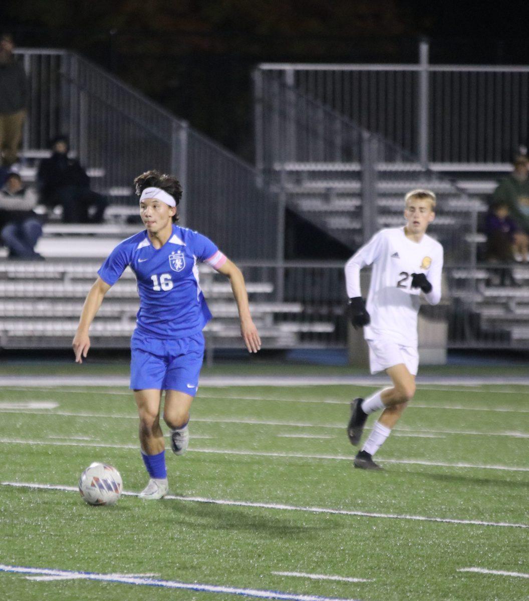 Senior Ethan Nguyen carries the ball down the field in the boys soccer second round matchup against Buckeye Valley High School Oct. 28.