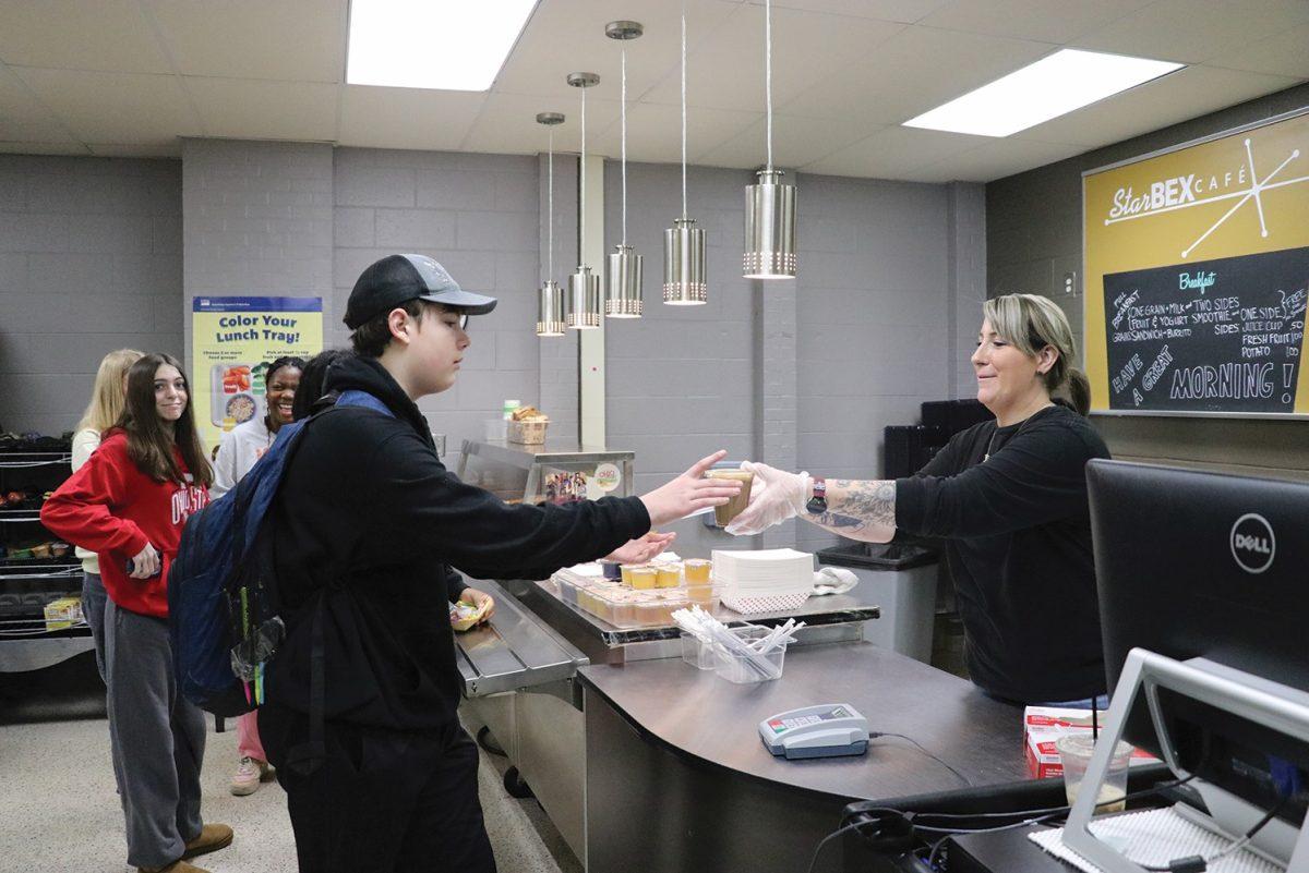 Freshman Rocco Isaly is served the free breakfast Friday, Dec. 1 by cook Amber Wise. (Photo by Ruthie Gravelle)