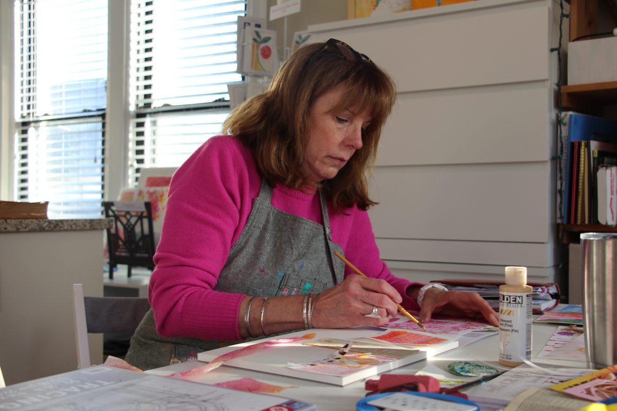 Creative mentor and artist Abby Feinknopf paints patterns on paper for a mixed media collage project in her Bexley studio. (Photo by Ruthie Gravelle)