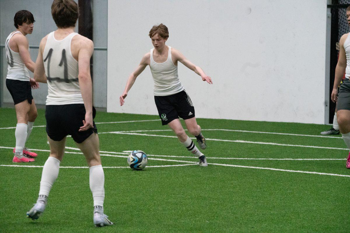 Junior Dylan Horn clears the ball across the field to his offensive teammates Saturday, March 2 at Resolute Athletic Complex. (Photo by Livi Tuber)