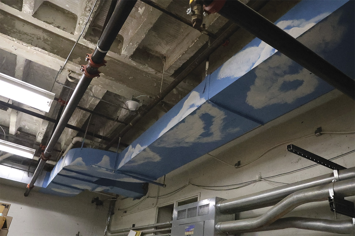 Clouds are painted on a air vent
in the basement. (Ruthie Gravelle)