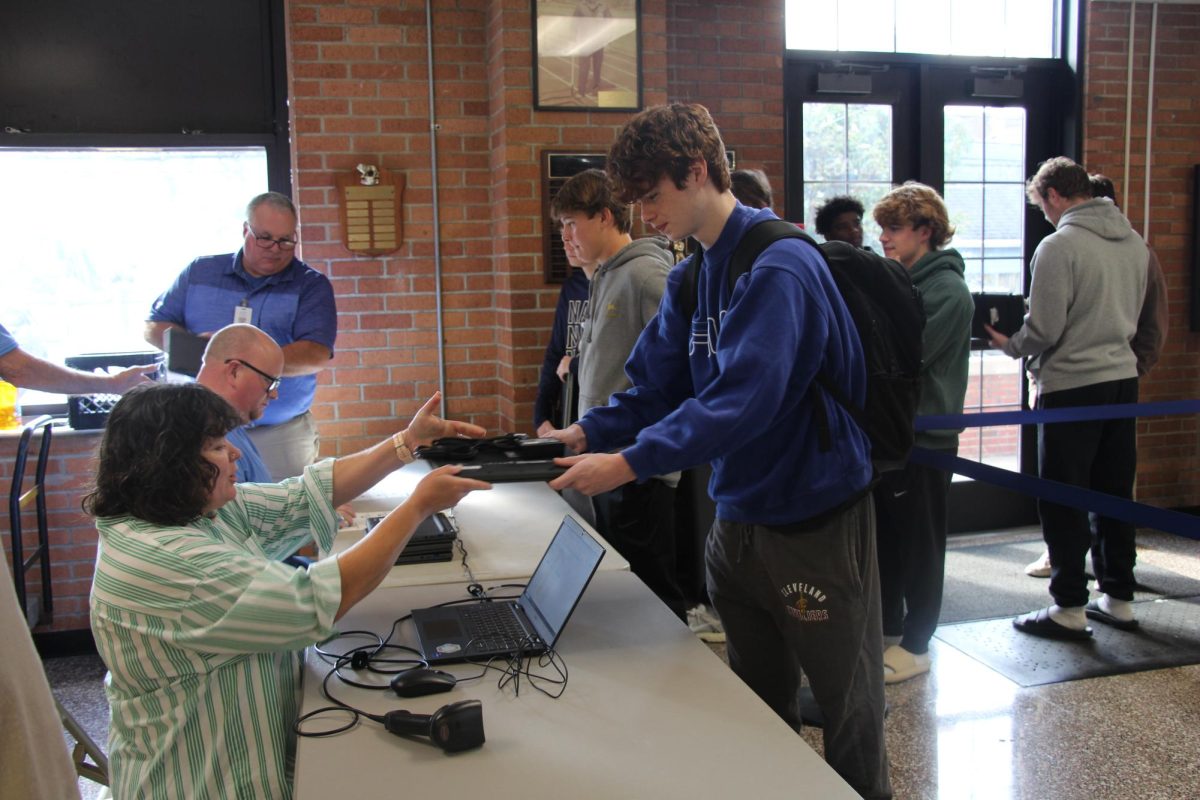 Senior Jack McMaster picks up his new Chromebook during the senior seminar on Oct. 16.