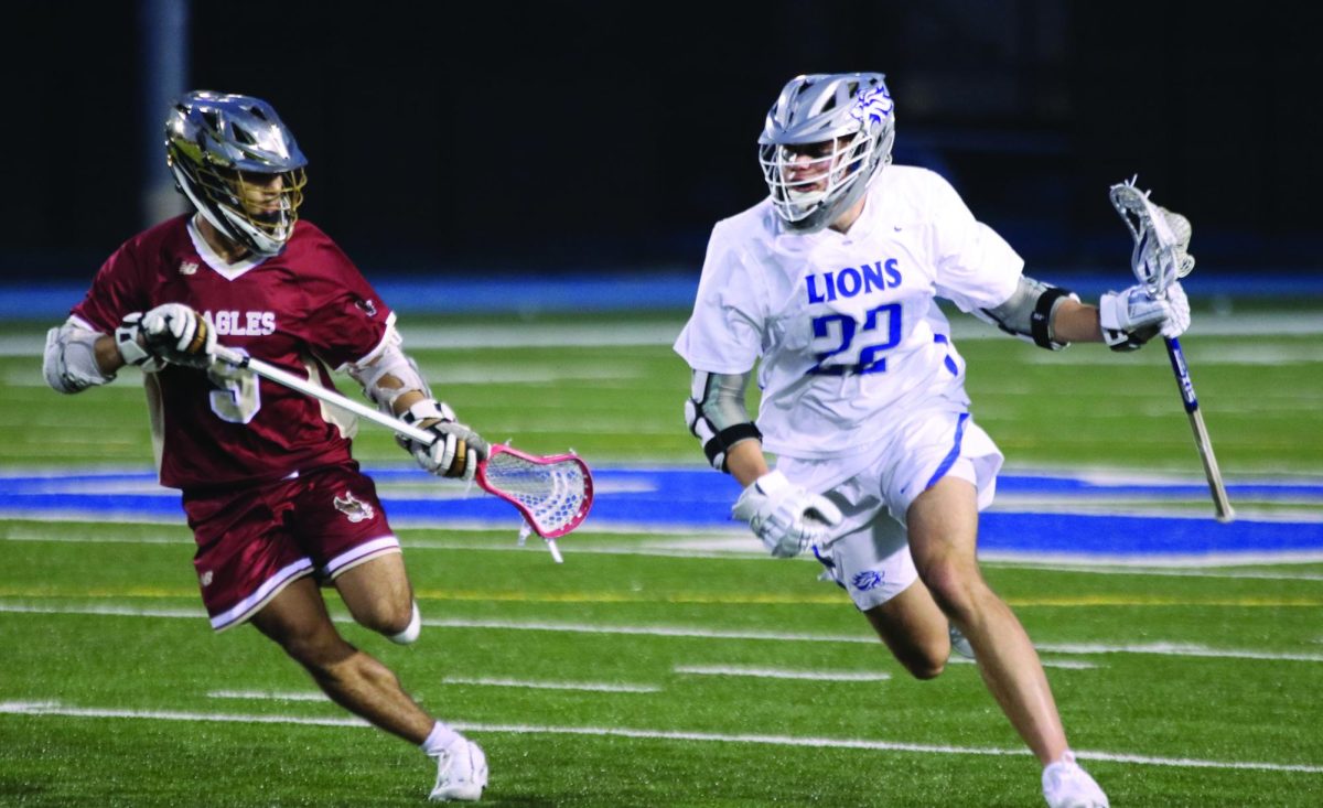 Senior Reed Solar drives past a defender in an overtime game against Bishop Watterson March 28 at home.