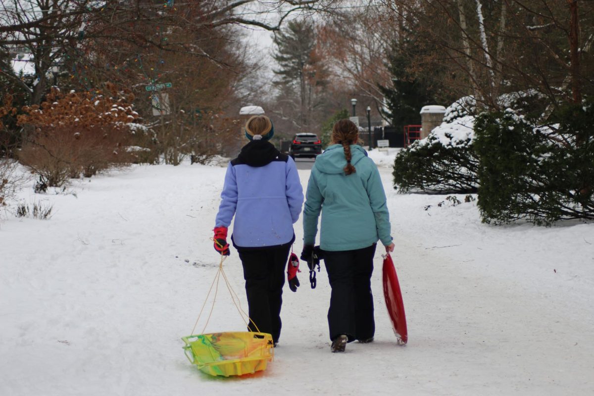 Bexley graduate Evie Holzhall and Bexley resident Claire Bahlmann head
home after a day of sledding at Miller’s Hill.