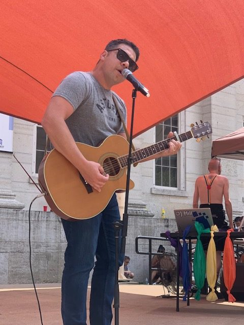 English teacher Drew Eberly performs at an outdoor event. (Photo credit Drew Eberly)