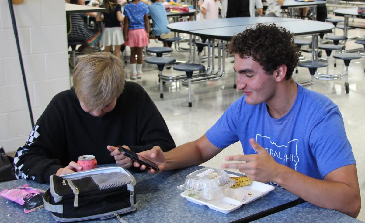 Sophomores Graham McCabe and Orien Abner go on their phones during lunch.