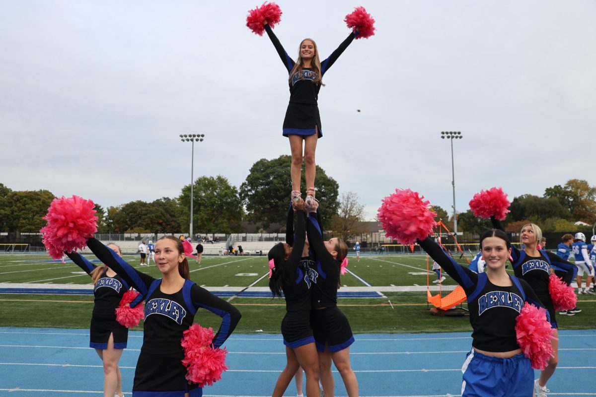 Varsity cheerleaders practice stunting as they prepare for the football game Oct. 10.