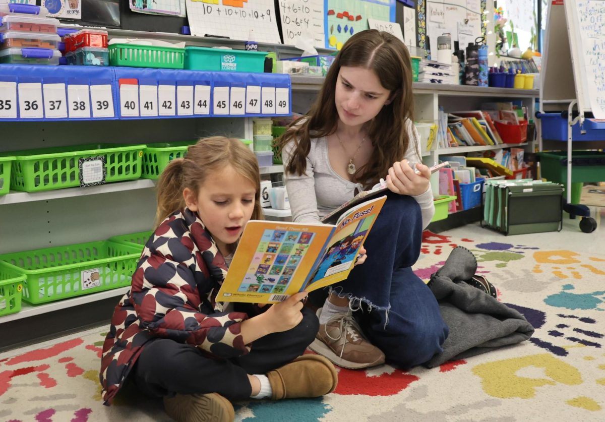 Senior Emily Wasserstrom helps a student with reading at Cassingham Elementary Oct. 29.