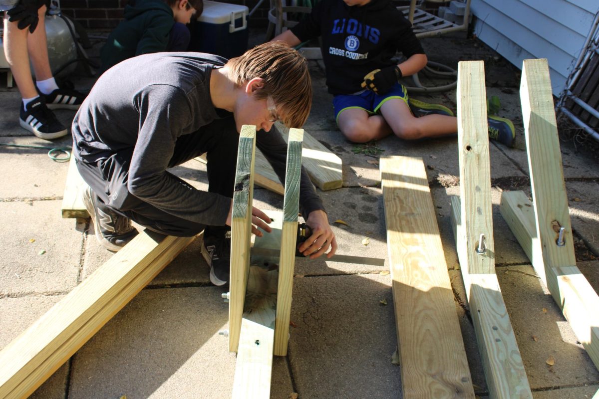 Senior David Haynes measures boards during his Eagle project workday Oct. 26.