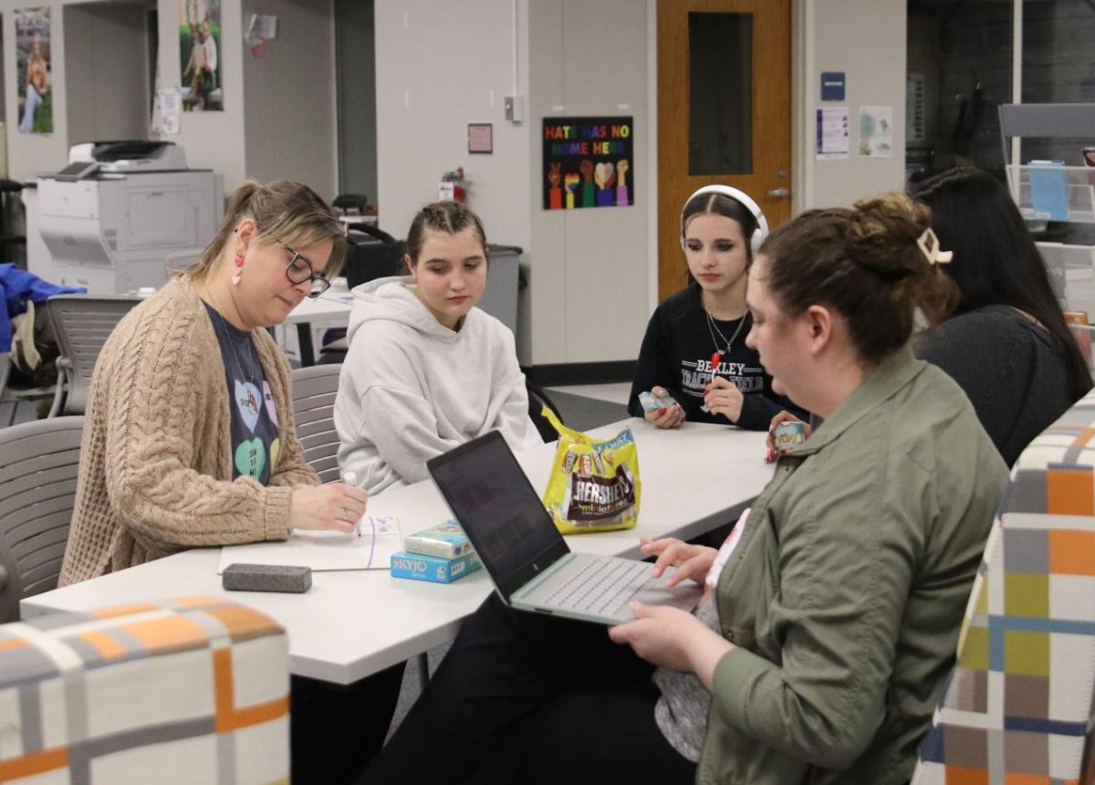 High school students play a card game with Reset and Recharge advisers Krupa Shah and Jennifer Kirk Thursday, Feb. 12.