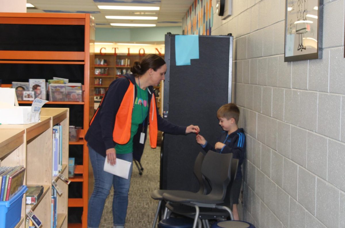 Substitute teacher Sara Beam finds kindergartner Ezra George in the Cassingham Library Friday, March 13.