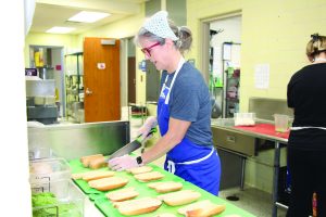 Cook Rachelle Jackson makes sandwiches for the school lunches.